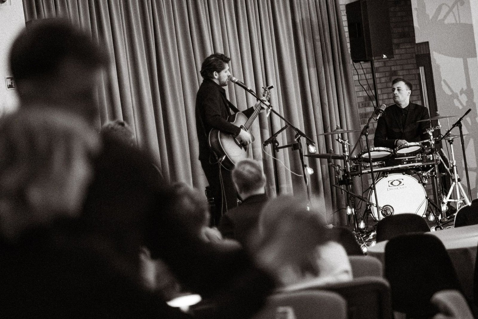 Justinas Stanislovaitis and the drummer in concert, black and white